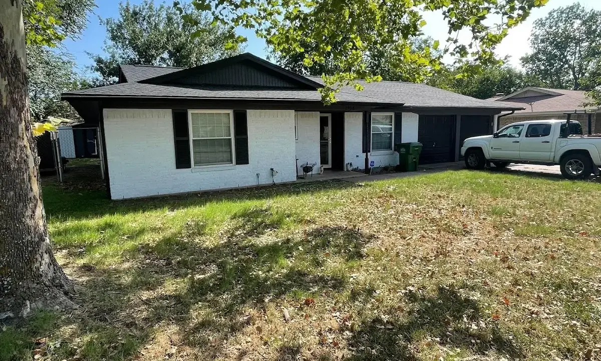 Professional roofing crew working on a residential roof in Alpena